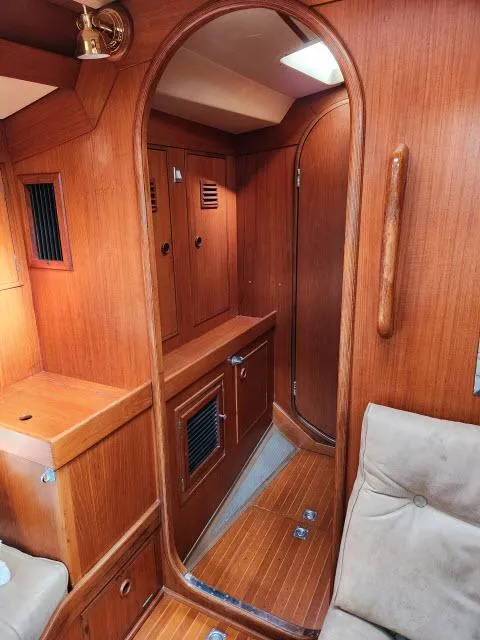 Slide: The Image of Interior of 1984 Nautor Swan 391 sailboat with wooden cabinetry and cozy seating. - 24