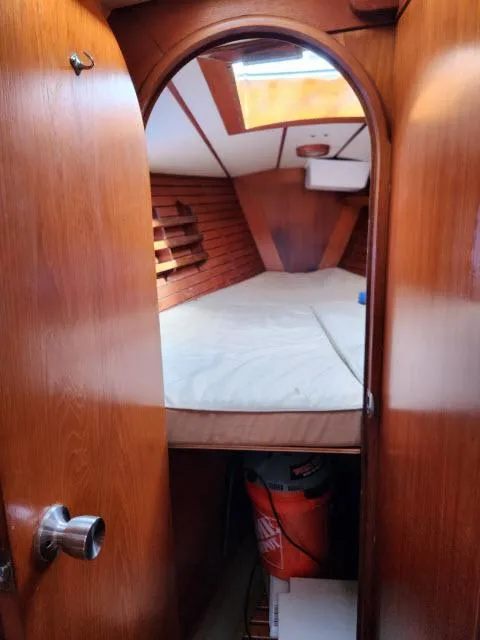 Slide: The Image of 1984 Nautor Swan 391 sailboat interior cabin with wooden finish and bed. - 26