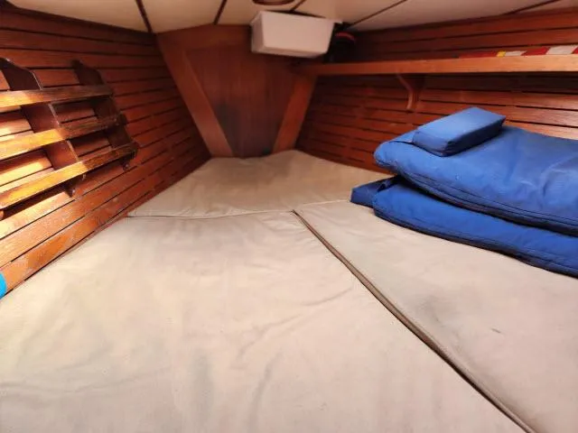 Slide: The Image of Cozy cabin interior of 1984 Nautor Swan 391 sailboat with wooden paneling and blue cushions. - 27