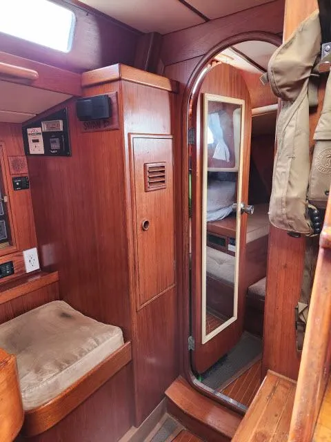 Slide: The Image of 1984 Nautor Swan 391 yacht interior with wooden finish and cozy seating. - 28