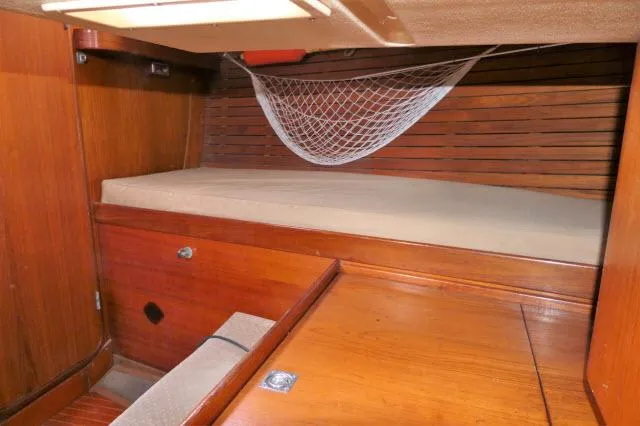 Slide: The Image of 1984 Nautor Swan 391 cabin with wooden interior and bed. - 32