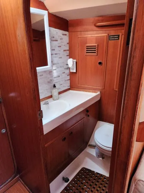 Slide: The Image of 1984 Nautor Swan 391 yacht bathroom with wooden cabinetry and white sink. - 35