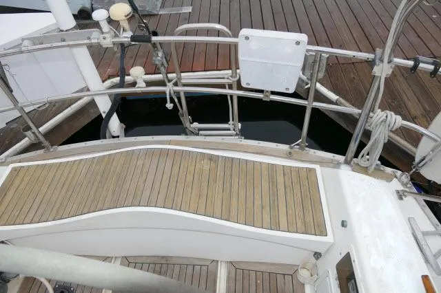 Slide: The Image of Nautor Swan 391 (1984) yacht stern deck with wooden flooring and railing. - 39