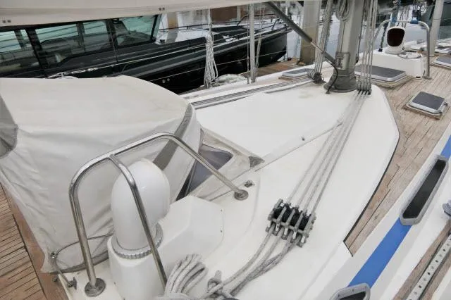Slide: The Image of 1984 Nautor Swan 391 sailboat deck with rigging and covered equipment. - 44