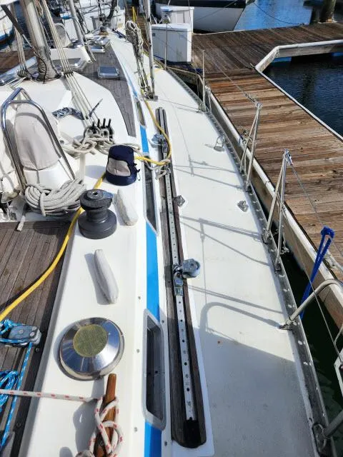 Slide: The Image of 1984 Nautor Swan 391 sailboat deck with winches and rigging at a marina. - 46