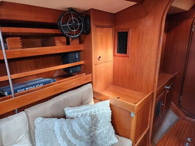 Slide: The Image of Interior of 1984 Nautor Swan 391 sailboat with wooden shelves and cozy seating. - 5