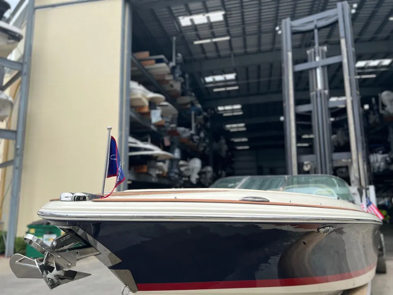 Slide: The Image of 2022 Chris-Craft Launch 27 boat docked in a storage facility. - 13