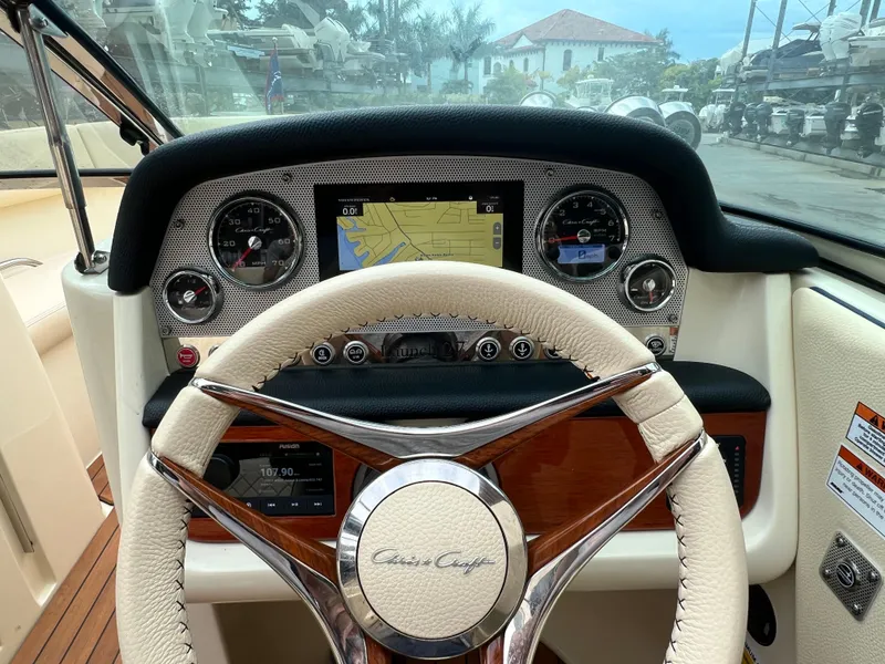 Slide: The Image of 2022 Chris-Craft Launch 27 dashboard with steering wheel and navigation display. - 17