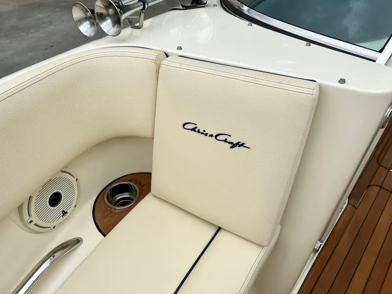 Slide: The Image of 2022 Chris-Craft Launch 27 boat interior with beige seating and logo. - 23