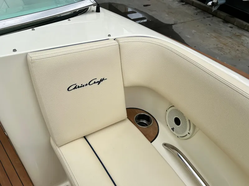 Slide: The Image of 2022 Chris-Craft Launch 27 boat interior with beige seating and logo. - 24