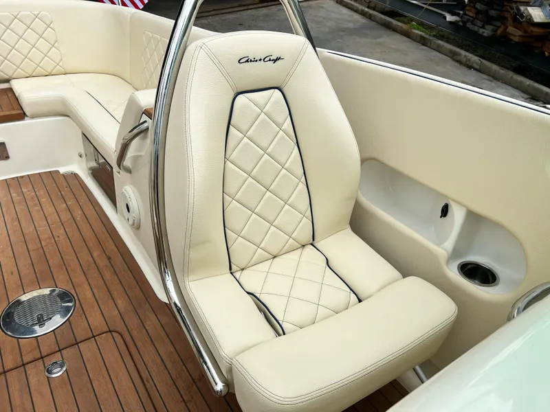 Slide: The Image of 2022 Chris-Craft Launch 27 boat interior with luxurious cream leather seating and teak flooring. - 25