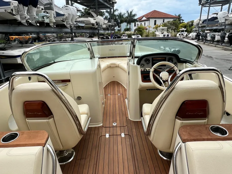 Slide: The Image of 2022 Chris-Craft Launch 27 boat interior with luxurious seating and wooden flooring. - 29