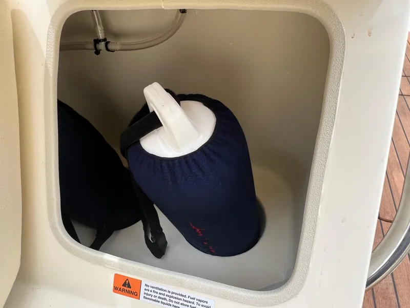 Slide: The Image of Storage compartment on a 2022 Chris-Craft Launch 27 boat with safety equipment. - 31