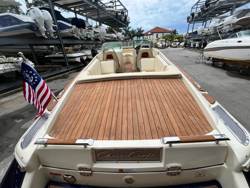 Slide: The Image of 2022 Chris-Craft Launch 27 boat with teak deck and American flag. - 32