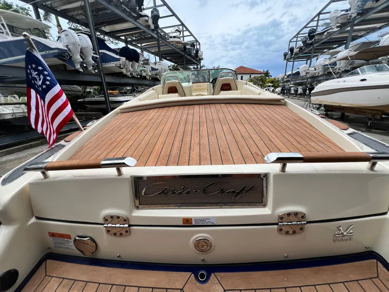 Slide: The Image of 2022 Chris-Craft Launch 27 boat with wooden deck, docked in a marina. - 33