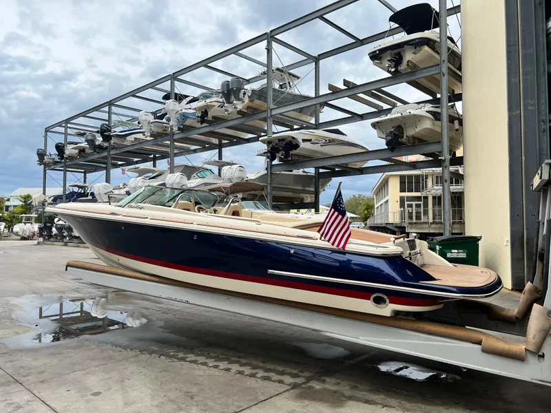Slide: The Image of 2022 Chris-Craft Launch 27 boat in storage facility with American flag. - 7
