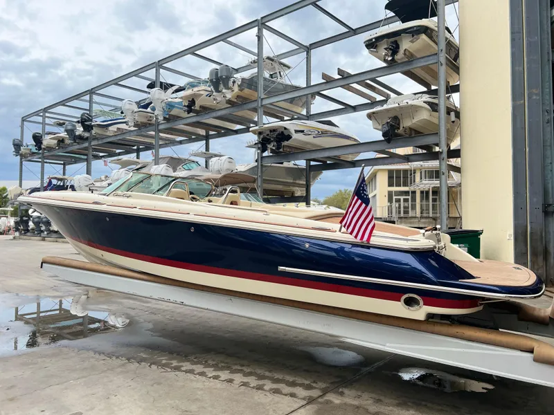 Slide: The Image of 2022 Chris-Craft Launch 27 boat in storage, featuring a sleek design and American flag. - 8