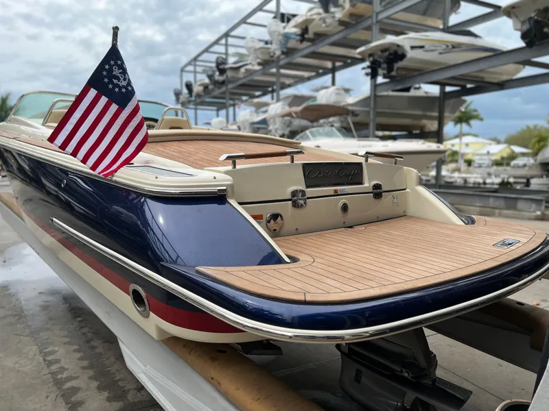 Slide: The Image of 2022 Chris-Craft Launch 27 boat with American flag in marina. - 9