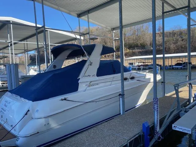 The Image of 2000 Sea Ray 310 Sundancer docked under a covered marina. - 0
