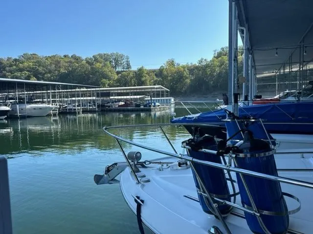 Slide: The Image of Sea Ray 310 Sundancer 2000 docked at a marina with other boats. - 3
