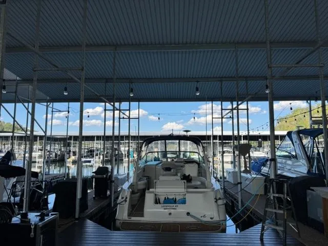 Slide: The Image of Sea Ray 310 Sundancer 2000 docked in a marina under a covered slip. - 9