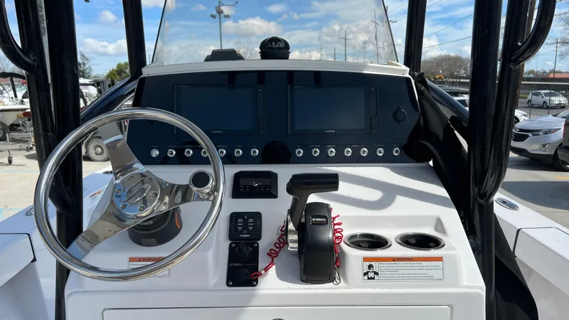 Slide: The Image of 2019 Sportsman 227 MASTERS Platinum boat dashboard with steering wheel and control panel. - 12