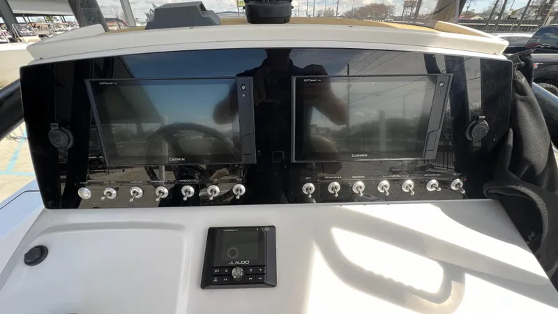 Slide: The Image of 2019 Sportsman 227 MASTERS Platinum boat dashboard with dual Garmin displays. - 13