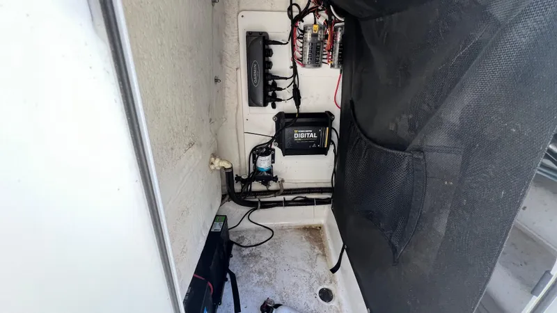 Slide: The Image of 2019 Sportsman 227 MASTERS Platinum boat electrical compartment with wiring and battery. - 14