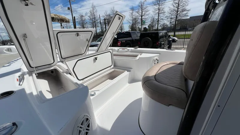 Slide: The Image of 2019 Sportsman 227 MASTERS Platinum boat interior with open storage compartments and seating. - 16