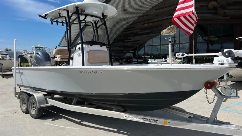 Slide: The Image of 2019 Sportsman 227 MASTERS Platinum boat on trailer with American flag. - 2