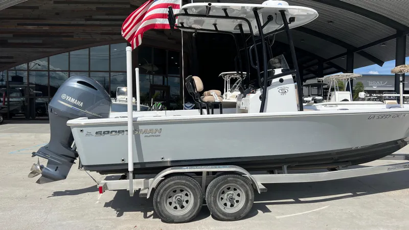 Slide: The Image of 2019 Sportsman 227 MASTERS Platinum boat on trailer with Yamaha outboard motor and American flag. - 3