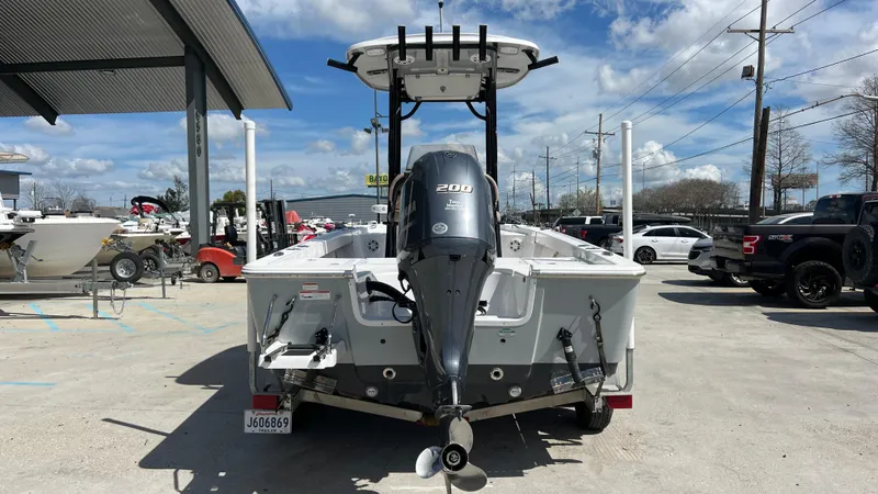 Slide: The Image of 2019 Sportsman 227 MASTERS Platinum boat with outboard motor, parked in a marina. - 4
