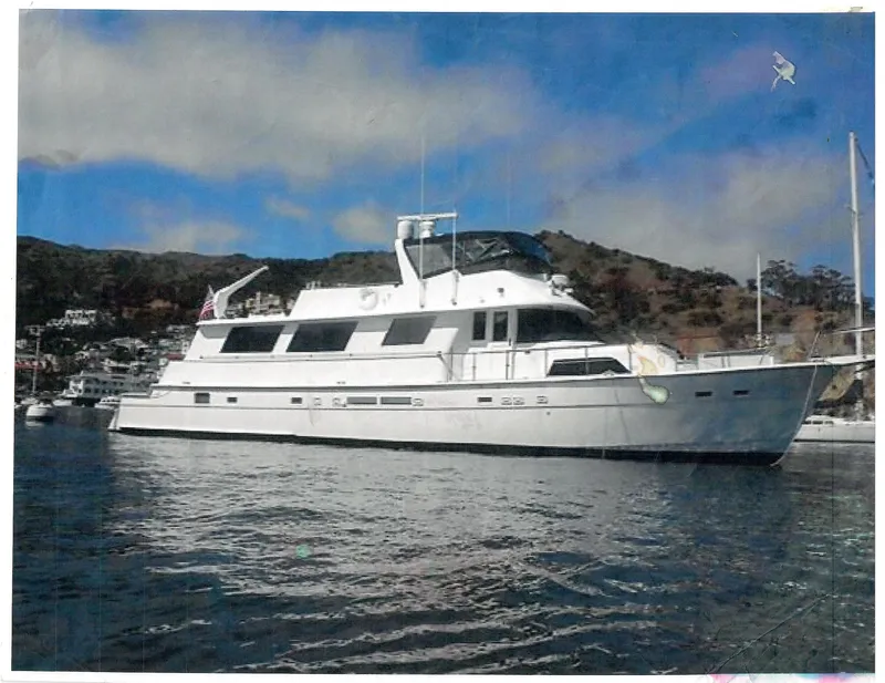 The Image of 1986 Hatteras 70' Cockpit Motor Yacht anchored in a scenic bay. - 0