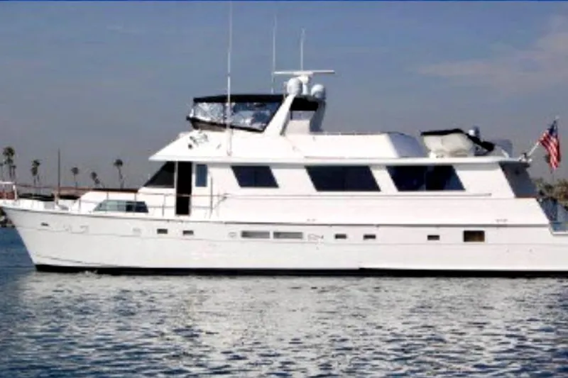 Slide: The Image of 1986 Hatteras 70' Cockpit Motor Yacht on calm waters. - 1