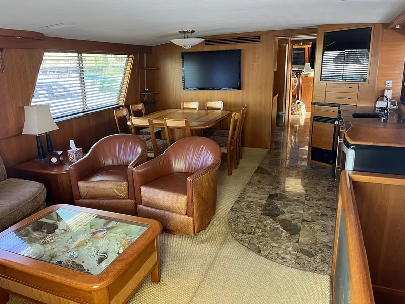 Slide: The Image of Interior of 1986 Hatteras 70' Cockpit Motor Yacht with dining area and lounge. - 15