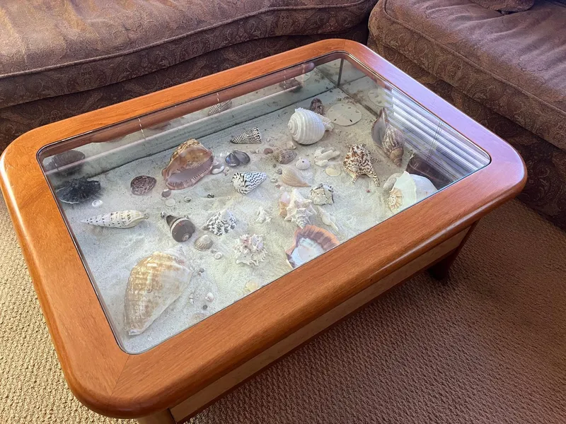 Slide: The Image of Glass-top coffee table with seashell display on a 1986 Hatteras 70' Cockpit Motor Yacht. - 22
