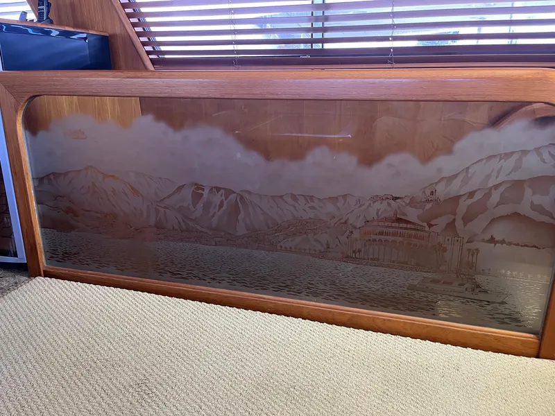 Slide: The Image of Etched glass artwork inside 1986 Hatteras 70' Cockpit Motor Yacht, featuring a mountain and lake scene. - 23