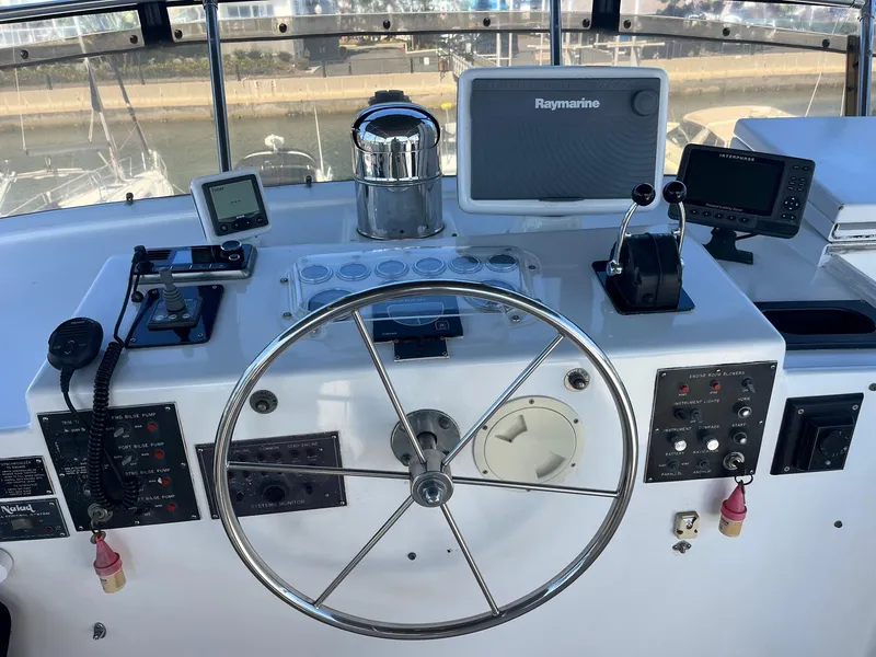 Slide: The Image of Control panel of a 1986 Hatteras 70' Cockpit Motor Yacht with Raymarine electronics. - 28