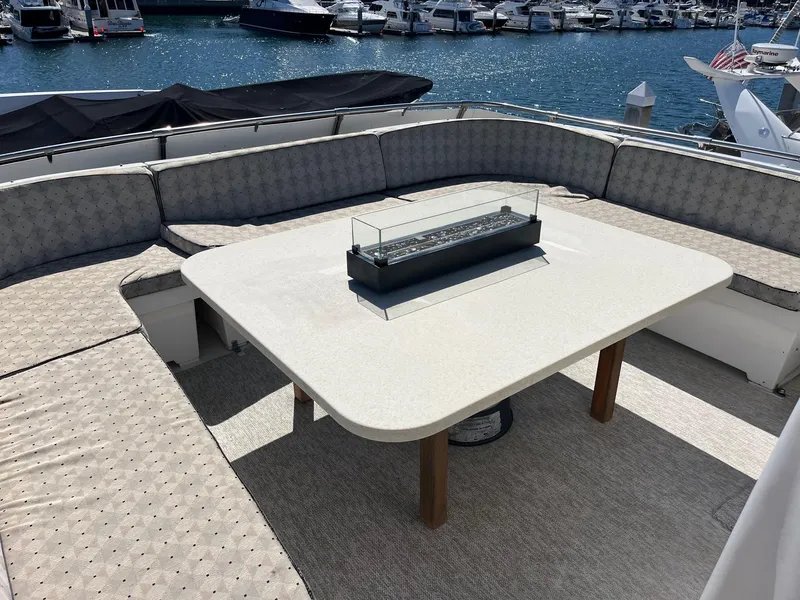 Slide: The Image of Outdoor seating area on 1986 Hatteras 70' Cockpit Motor Yacht, with marina view. - 33