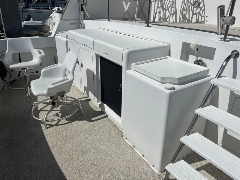 Slide: The Image of 1986 Hatteras 70' Cockpit Motor Yacht deck with seating and storage. - 37