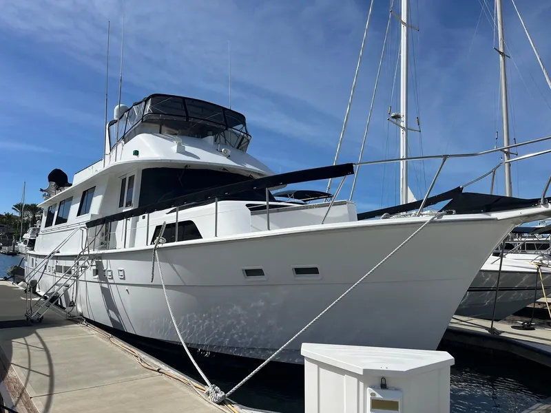 Slide: The Image of 1986 Hatteras 70' Cockpit Motor Yacht docked at marina. - 4