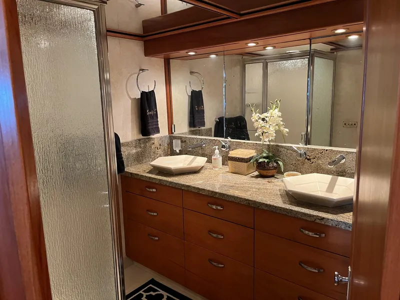 Slide: The Image of Luxurious bathroom on a 1986 Hatteras 70' Cockpit Motor Yacht with dual sinks and granite countertop. - 42