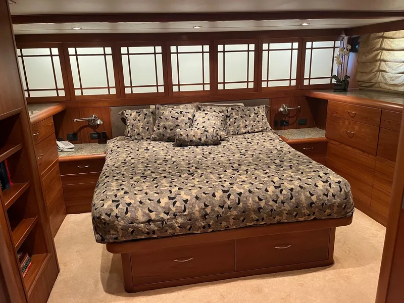 Slide: The Image of Luxurious master bedroom in 1986 Hatteras 70' Cockpit Motor Yacht with wood cabinetry. - 5
