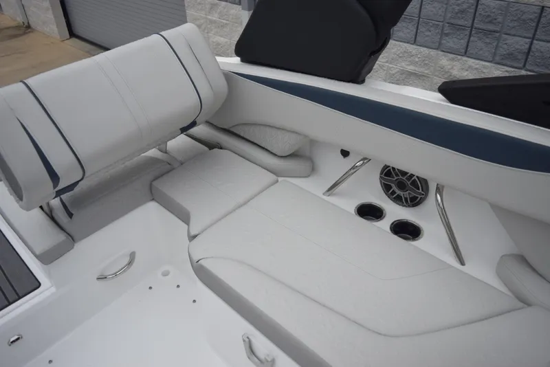 Slide: The Image of 2024 Hurricane SunDeck 2600 OB boat interior with cushioned seating and cup holders. - 11