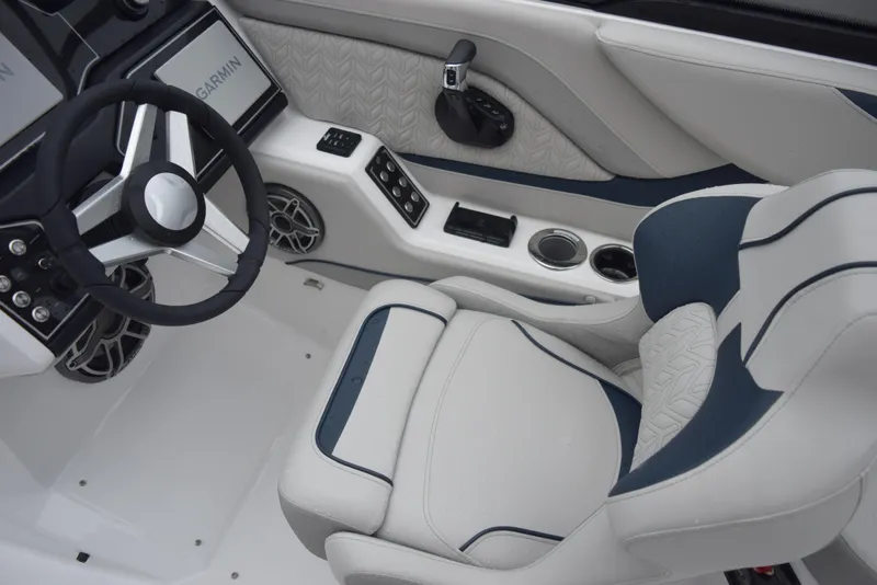 Slide: The Image of 2024 Hurricane SunDeck 2600 OB boat interior with steering wheel and captain's chair. - 13