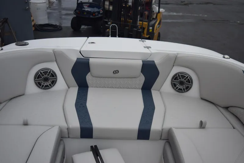 Slide: The Image of 2024 Hurricane SunDeck 2600 OB boat interior with cushioned seating and built-in speakers. - 19