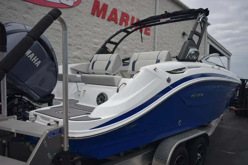 Slide: The Image of 2024 Hurricane SunDeck 2600 OB boat on trailer, blue and white exterior, Yamaha outboard motor. - 4