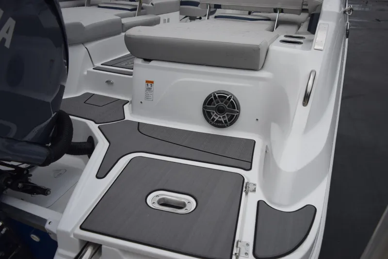 Slide: The Image of 2024 Hurricane SunDeck 2600 OB boat deck with cushioned seating and speaker. - 7