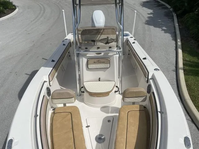 Slide: The Image of 2023 Sea Chaser 22 HFC boat with center console and seating, parked on a sunny day. - 10