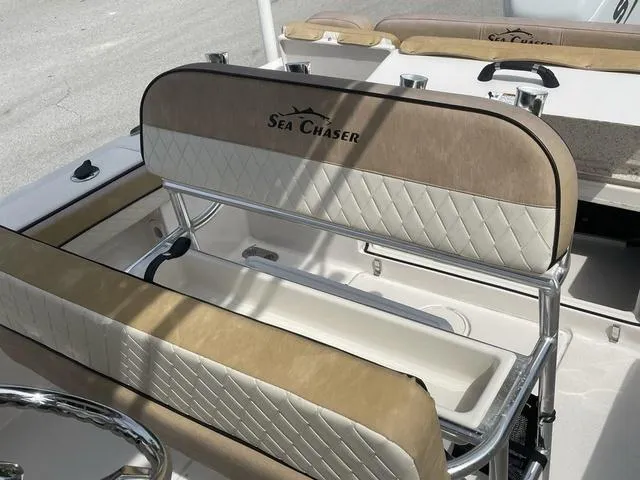 Slide: The Image of 2023 Sea Chaser 22 HFC boat interior with tan cushioned seating and diamond-stitched backrests. - 15